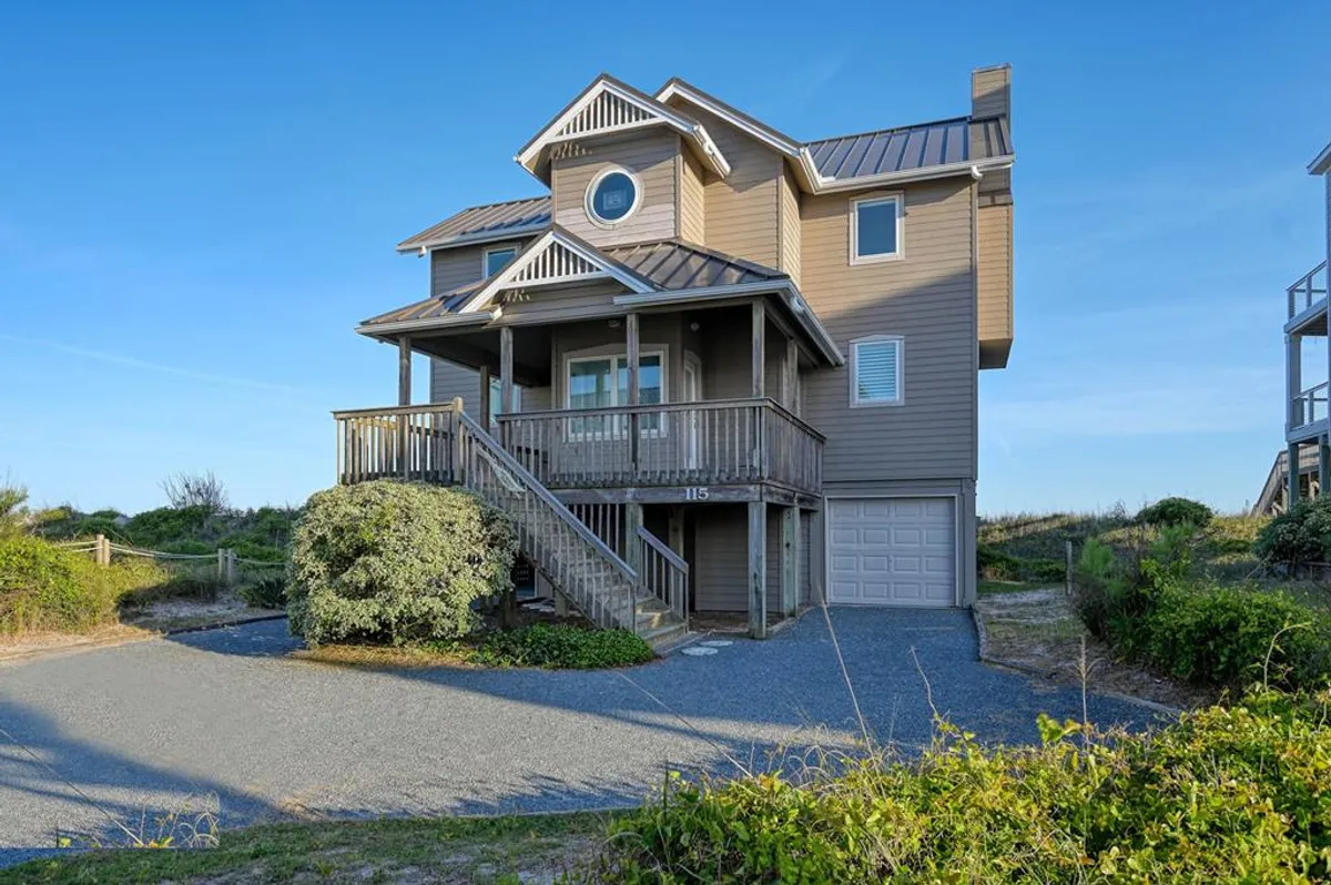 The photo showcases the home's welcoming front porch and distinctive architecture, framed by lush greenery. The inviting outdoor space represents the tranquil, family-friendly neighborhood atmosphere, suggesting both community interaction and peaceful retreat.